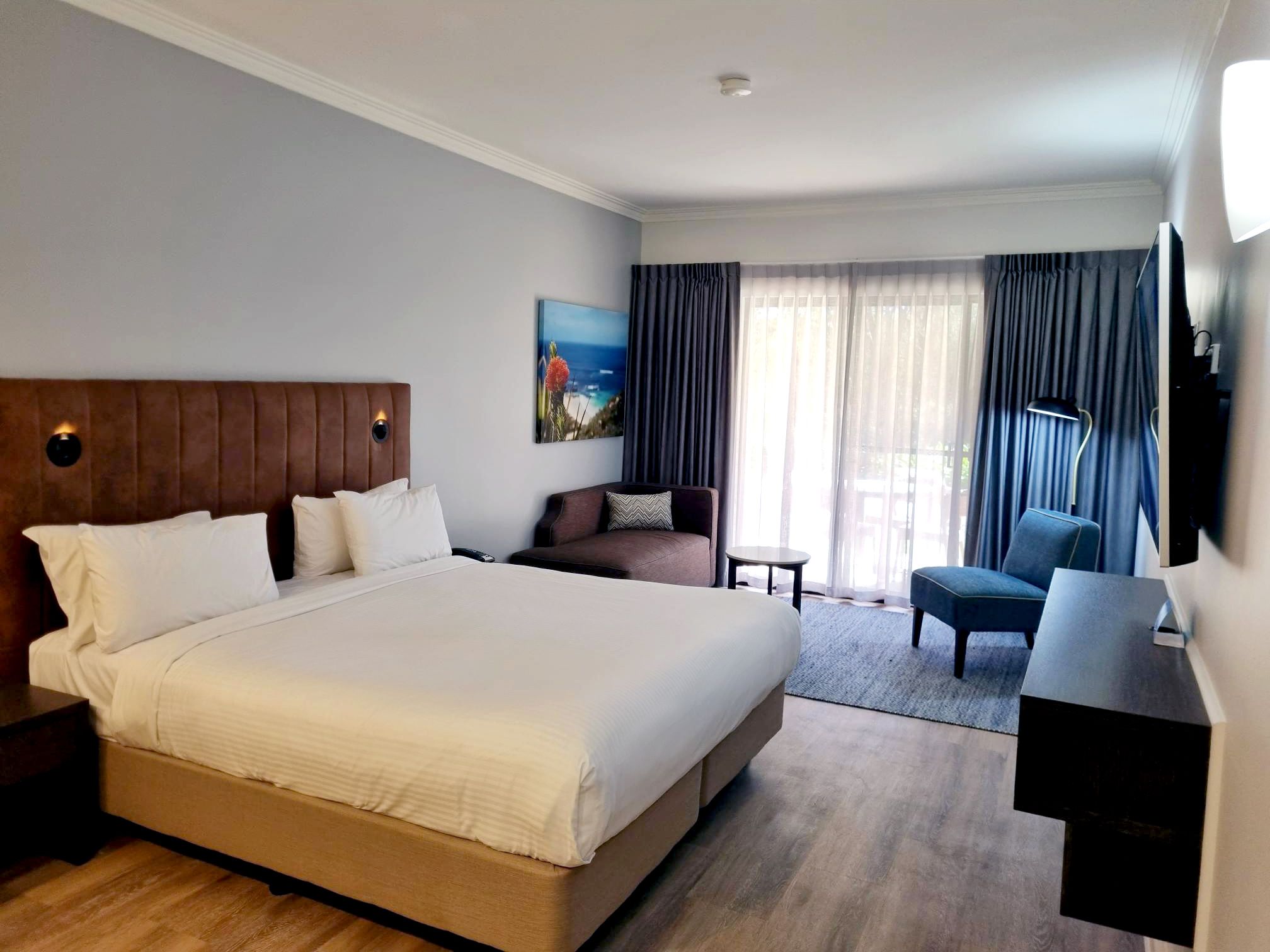 white bed linen near brown wooden door